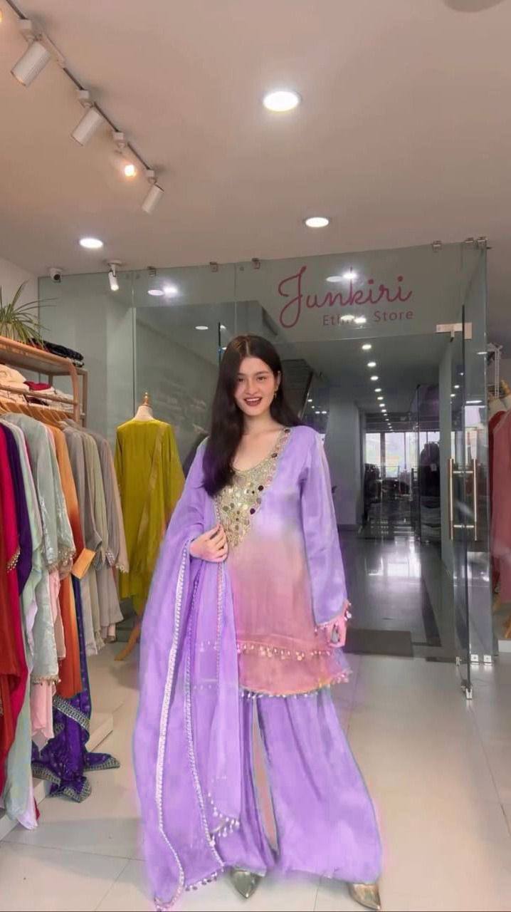 Woman in a lavender traditional outfit standing in a store with 'Junkkiro' branding.