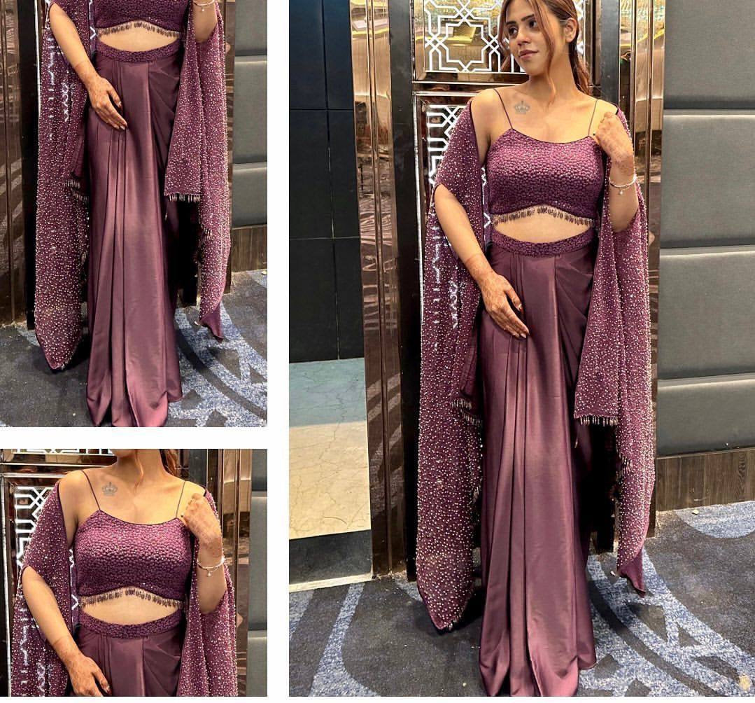 Woman wearing a mauve outfit with a matching shawl in an elevator.